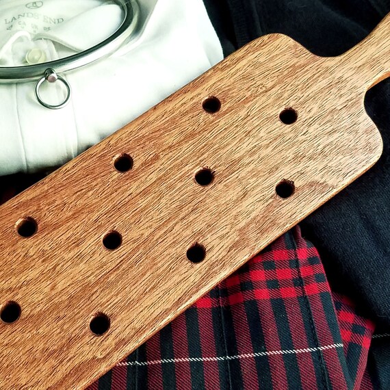 Spanking paddle with holes
